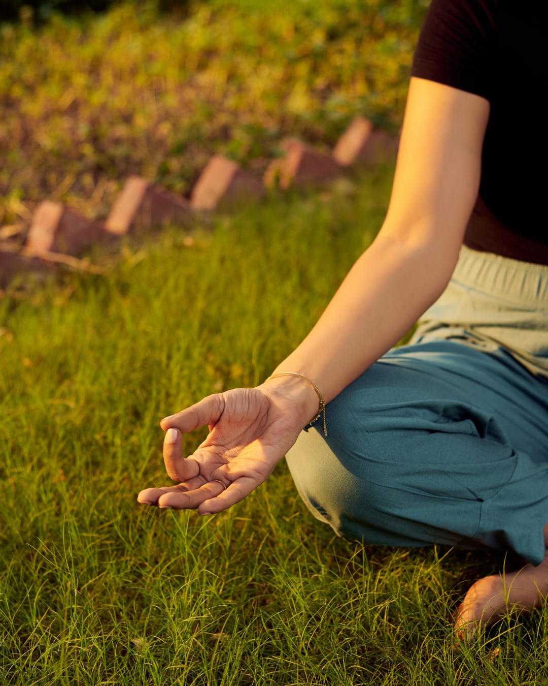 Seated in gyan mudra on the grass